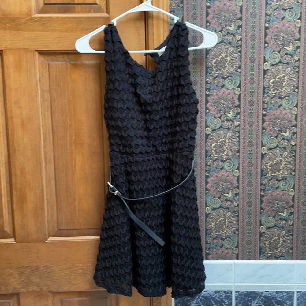 Juniors black cocktail dress with black belt in new condition.